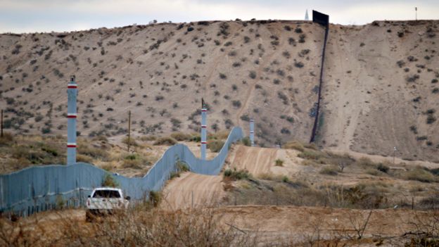 A US Border Patrol agent drives near the US-Mexico border fence in Sunland Park, New Mexico