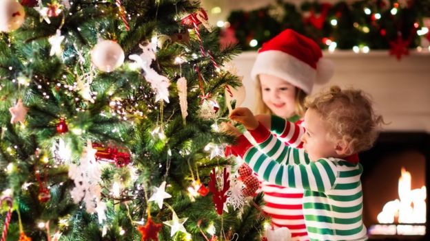 Children decorating a Christmas Tree