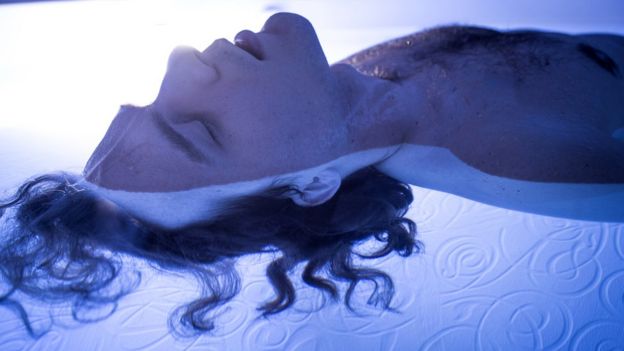 Close-up of man with eyes shut in flotation tank