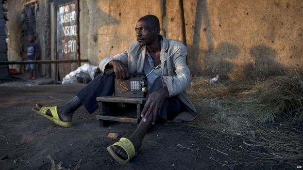 A man listens to the news on the radio in an opposition neighbourhood of Bujumbura, on July 22, 2015, following the presidential election of July 21 2015