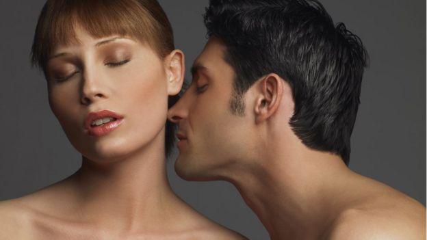 Homem beija o pescoço de mulher com olhos fechados