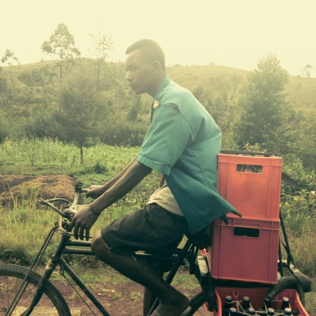 Cyclists with bottles on the back of his bicycle