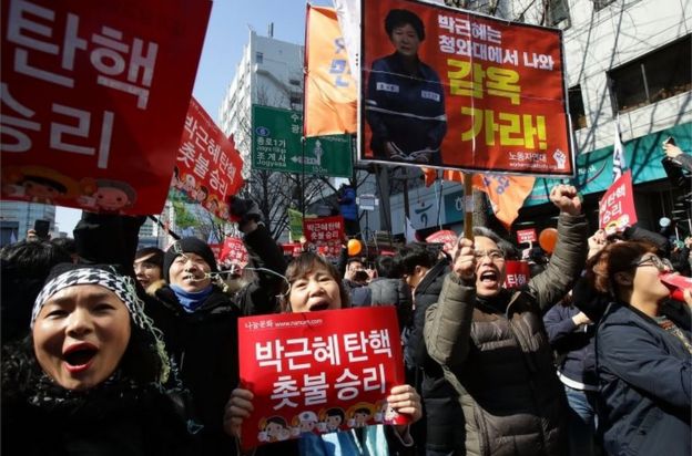 South Koreans celebrate after hearing the Constitutional Court