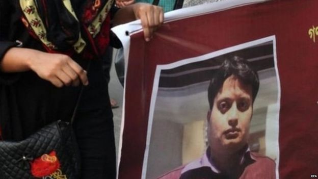 Mourner with a poster of Ananta Bijoy Das