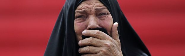 An Iraqi woman grieves at the scene of a deadly suicide car bomb attack in Baghdad on 9 June