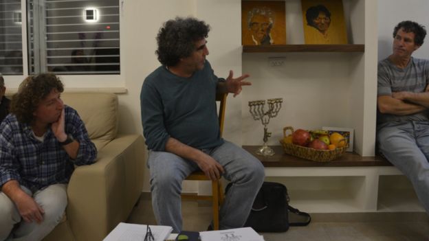 Meron Rapoport (c) and Eliaz Cohen (l) from Kfar Etzion settlement hold a 'One Homeland' meeting in Ofra settlement (Jan 2016)