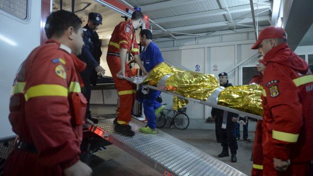 Paramedics carry an injured person at a hospital in Bucharest, Romania