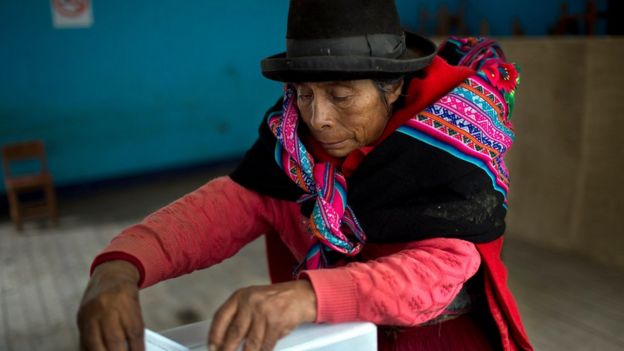 A Quechua indigenous woman casts her vote during general elections in Iquicha, Peru, Sunday, April 10, 2016