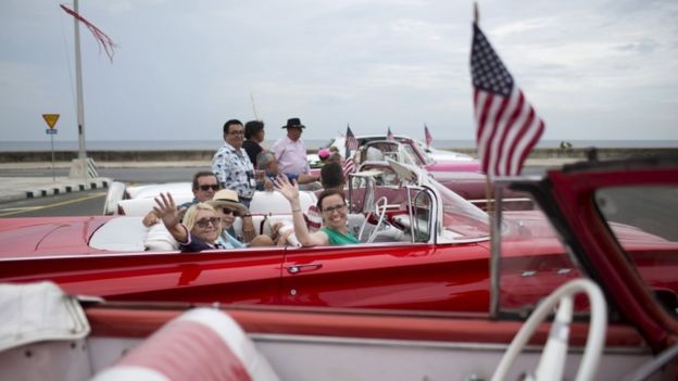 US citizens ride a vintage car in Havana