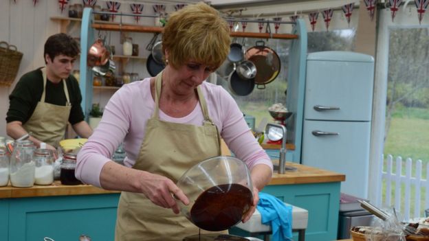 Jane applying the glaze to her cake in Great British Bake Off