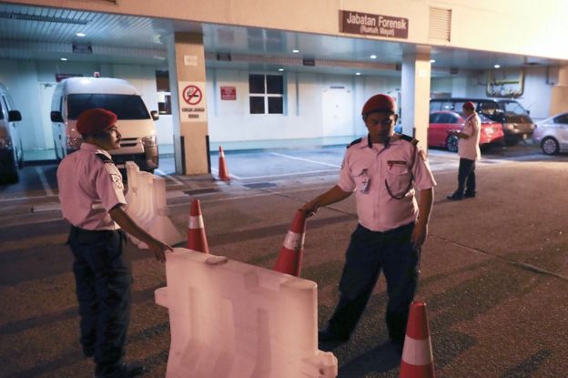 Hospitalsecurity personnel block the entrance of the forensic department at a hospital in Putrajaya, Malaysia, 14 February
