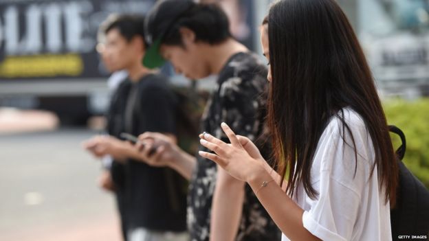 People use their smartphones on 16 July, 2014 in Tokyo, Japan