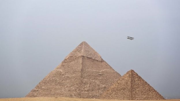 Egyptian medical doctor and pilot, Yasser Mohammed Minsy, and Belgian commercial pilot Cedric Collette, fly a vintage airplane during a rally across Africa, at the Giza Pyramids in Egypt (13 November 2016)