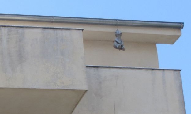 Grey soft toy hanging from roof