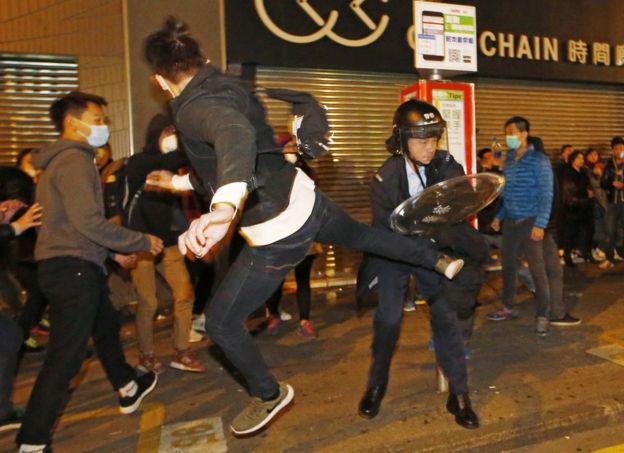 A protester kicks a riot police in Mong Kok district of Hong Kong, Tuesday, 9 February 2016.