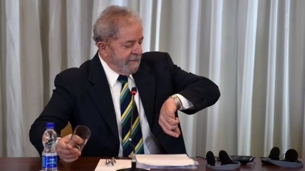 Brazilian former president Luiz Inacio Lula da Silva glances at his wristwatch before the start of a press conference in Sao Paulo, Brazil on March 28, 20