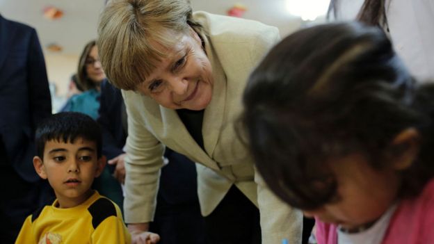 German Chancellor Angela Merkel talks with refugee children at a preschool, during a visit to a refugee camp on April 23, 2016 on the Turkish-Syrian border in Gaziantep