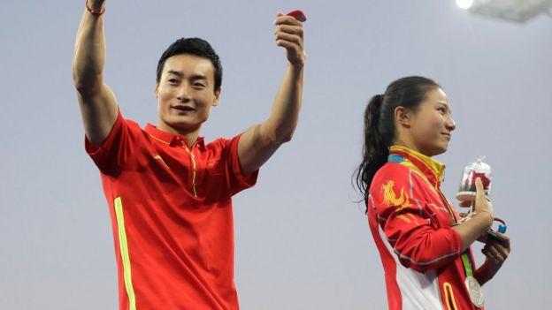 Qin Kai gives a thumbs up after silver medallist He Zi accepted his proposal