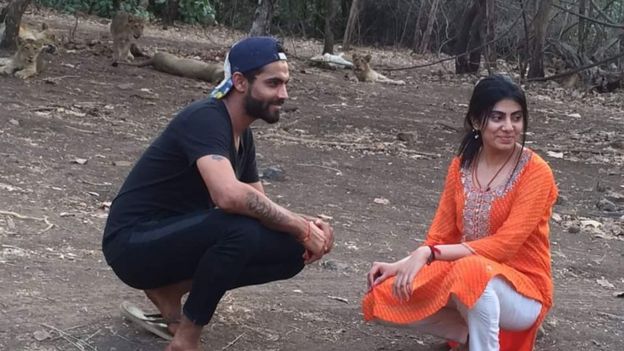 Cricketer Ravindra Jadeja and his wife Reeva Solanki pose with endangered lions at Gir National Park and Sanctuary in India's Gujarat state.