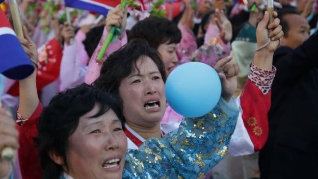 Women are overcome with emotion as they parade past North Korean leader (10 October 2015)