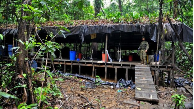 A Colombian soldier stands guard inside a cocaine laboratory in the forest area of Buenaventura, Valle del Cauca department, Colombia, on March 17 2010.