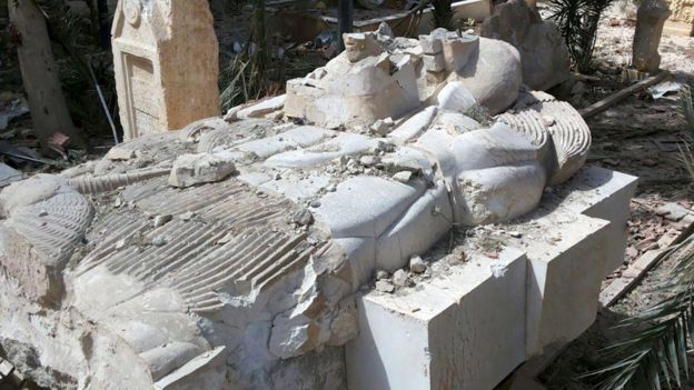 A view shows a damaged artefact at the entrance of the museum of the historic city of Palmyra, after forces loyal to Syria