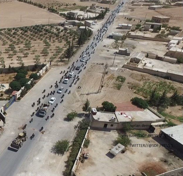 Photo released by the Syrian Democratic Forces (SDF) that it says shows Islamic State militants using human shields to flee the Syrian of Manbij in a convoy (12 August 2016)