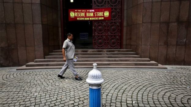 A man walks past closed Reserve Bank of India during nationwide general strike called by Communist Party of India (Marxist) and all trade unions in Calcutta, eastern India, 02 September 2016.