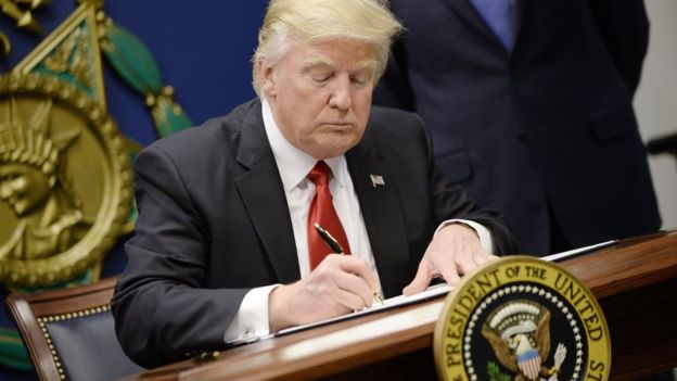 US President Donald Trump signs executive orders in the Hall of Heroes at the Department of Defence on 27 January, 2017 in Arlington, Virginia