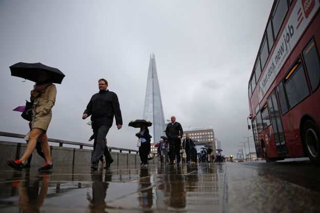 Commuters head into the City of London across London Bridge, 27 June