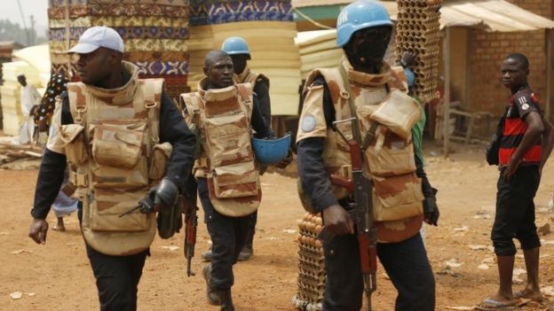 UN peacekeepers from Congo Brazzaville walk in the PK5 district after unloading a truck containing voting material and ballots at a polling station in Bangui, Central African Republic (13 January 2016)