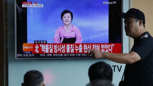 A North Korean TV presenter, watched here in the South, reads out the news