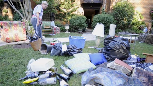 A South Carolina woman assesses the damage to her mother's home in Columbia, South Carolina on 5 October 2015