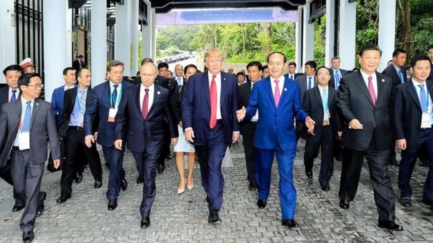 Donald Trump walks next to Vladimir Putin and other world leaders on the way to the 