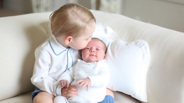 Prince George kisses his new baby sister Princess Charlotte.