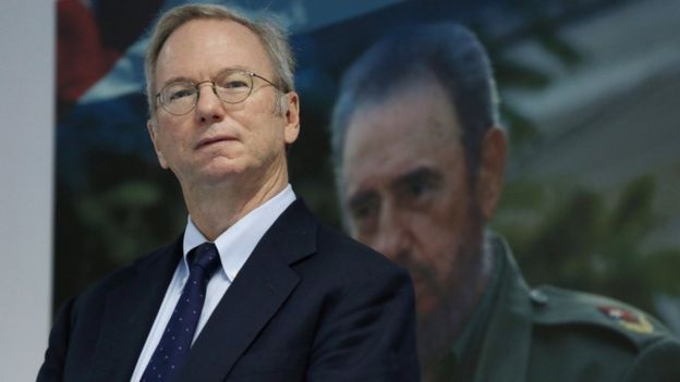 Eric Schmidt, chairman of Alphabet Inc. stands in front of a picture of former Cuba's President Fidel Castro before signing documents in Havana