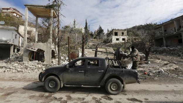 Forces loyal to Syrian President Bashar al-Assad drive a vehicle in the town of Rabiya (27 January 2016)