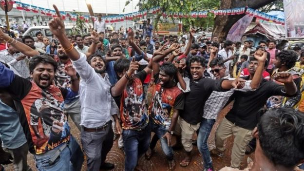 Indian fans of superstar Rajinikanth dances as they celebrates his much awaited film 