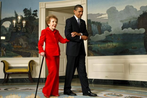 U.S. President Barack Obama escorts former first lady Nancy Reagan to a signing ceremony for the Ronald Reagan Centennial Commission Act in 2009