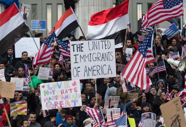 Yemeni Americans wave placards and flags at Brooklyn Borough Hall