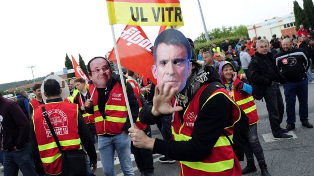Union members wear masks of French leaders at a protest at an industrial area in Vitrolles, near Marseille, on 26 May 2016