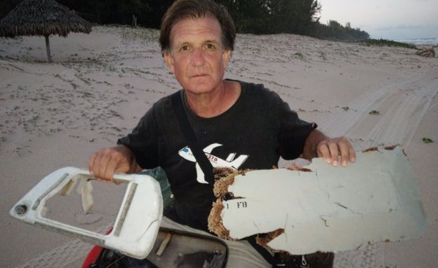 Blaine Gibson showing two pieces of possible MH370 debris found in Madagascar