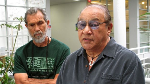 In this April 3, 2015 file photo, Office of Hawaiian Affairs trustee Peter Apo, right, speaks to reporters in Honolulu, as activist Walter Ritte listens.