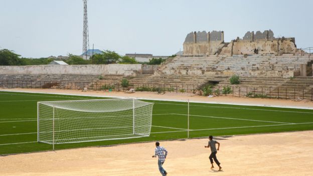 Two Somali men jogging near the football pitch inside Baanadir Stadium in the Somali capital Mogadishu in 2013
