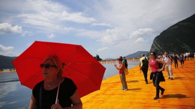 People walk on the Floating Piers installation by artist Christo 18/06/2016