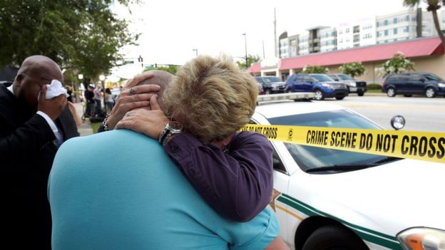 Terry DeCarlo, executive director of the LGBT Center of Central Florida, is comforted by Orlando City Commissioner Patty Sheehan - 12 June