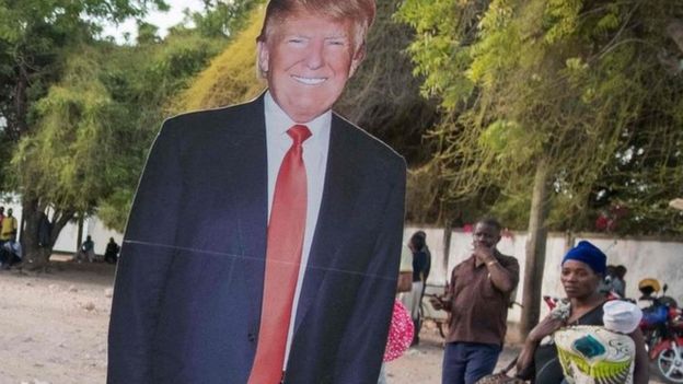 Cut outs of Hillary Clinton and Donald Trump are loaded onto a bus in Dar es Salaam, Tanzania on 7 November 2016