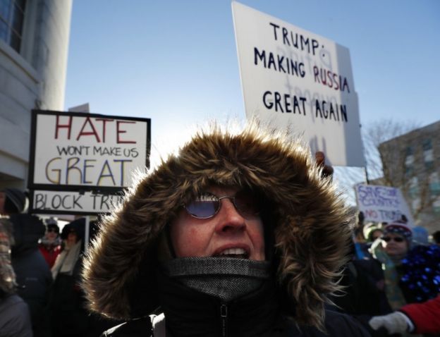 Anti-Donald Trump protesters brave the cold to rally outside the State House in Augusta, Maine, Monday, Dec. 19, 2016.