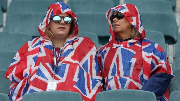 People in Union Jack rain covers