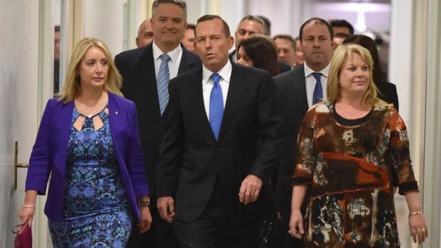 Australian Prime Minister Tony Abbott (C) walks though Parliament House in Canberra after he was dramatically ousted in a snap party vote forced by challenger Malcolm Turnbull on September 14, 2015